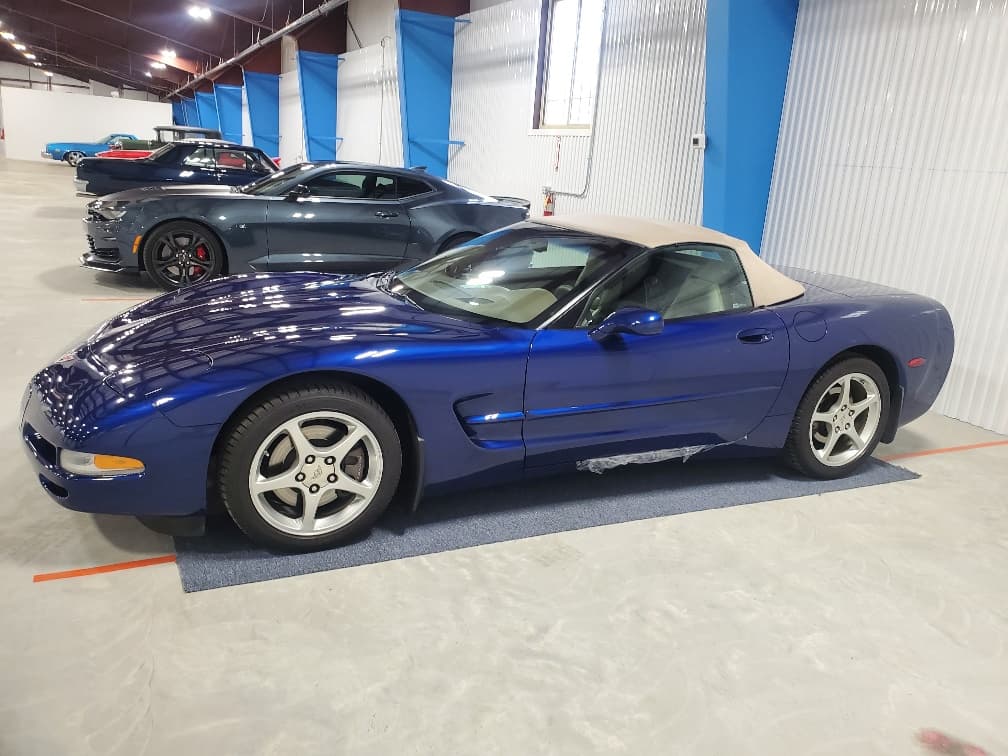 Corvettes parked in a row inside the vehicle building